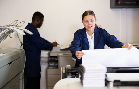 Female worker in a printing and press centar check print qualityの写真素材