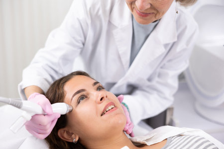 Young woman having face vacuum cleaning procedure