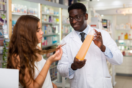 Doctor consulting young lady on haircareの写真素材