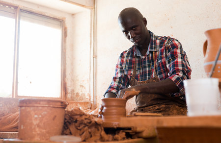 Potter working at pottery studioの写真素材