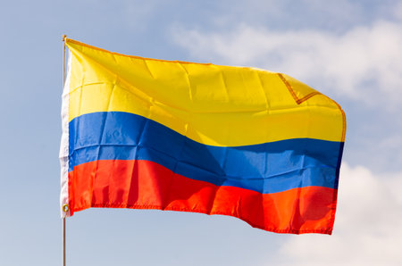 Flag of state of Colombia flutters against skyの写真素材