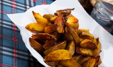 Tasty cooked baked in oven salted potatoes served at plate