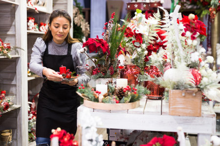 Owner of a flower shop prepares New Year decorations and arrangementsの写真素材