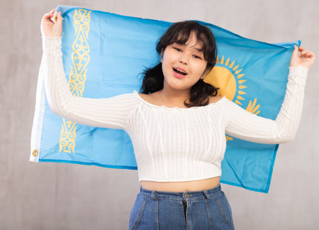 Smiling young girl holding flag of Kazakhstanの写真素材