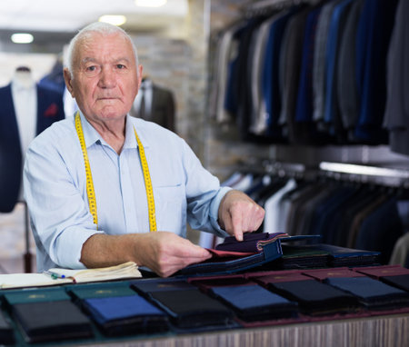 Portrait of an accomplished tailor with samples of fabric in atelierの写真素材