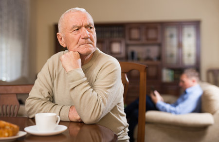 Frustrated aged man after quarrel with adult sonの写真素材