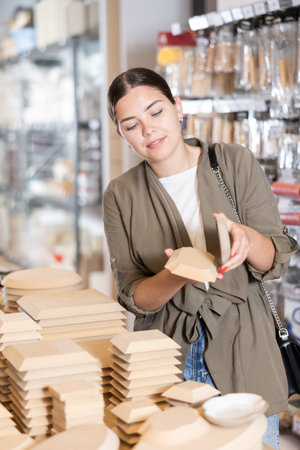 Young woman chooses blanks for making potteryの写真素材