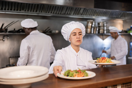 Portrait of woman chef giving out mealの写真素材