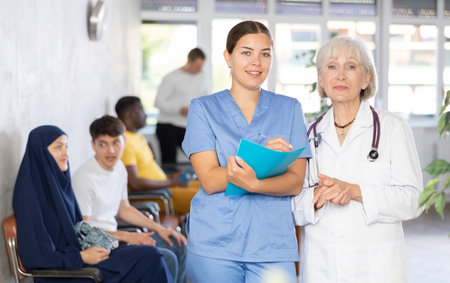 Portrait of an experienced female doctor and a young nurse in medical clinicの写真素材