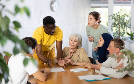 Group of multinational people making notes at tableの写真素材