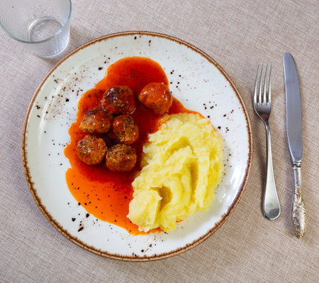 Meatballs in sauce served with mashed potatoesの写真素材