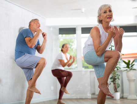 Group of elderly people dancing in fitness studioの写真素材