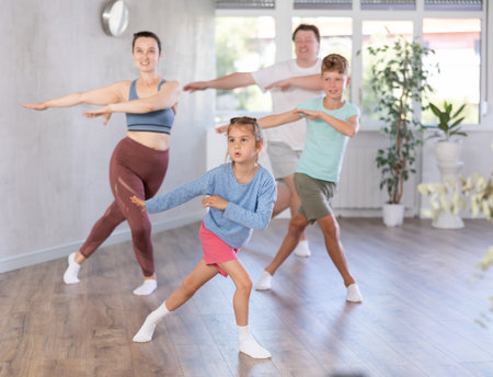 Family with two children dancing in studioの写真素材