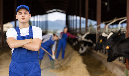 Portrait of young male farmer looking at camera during work on farmの写真素材