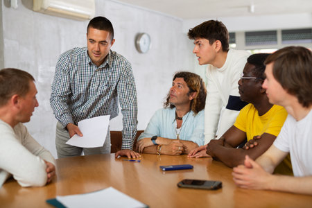 Group of men discussing something at the deskの写真素材