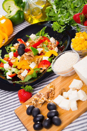 Ingredients and ready-made salad with rocketの写真素材