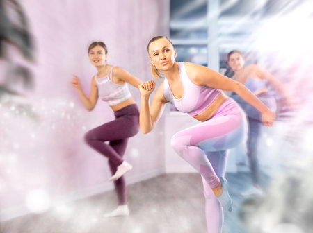 Positive women engaged in active dancingの写真素材