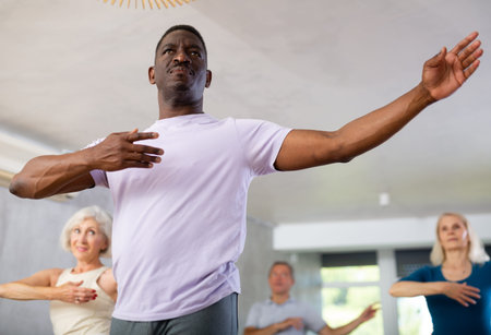 Group of multiethnic mature people dancing classical dance