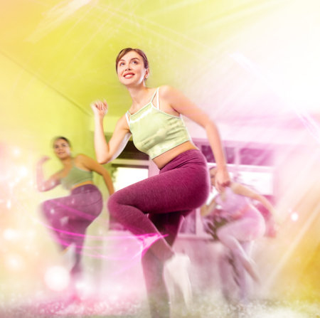 Positive women engaged in active dancingの写真素材