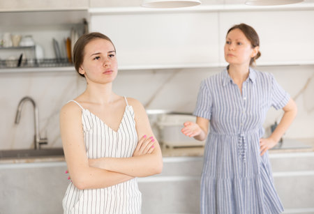 Domestic quarrel - mom scolds adult daughter for bad deedの写真素材