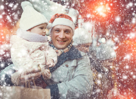 Man and little daughter at Christmas marketの写真素材