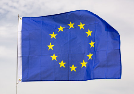 Flag of European Union waving on cloudy sky during daytimeの写真素材