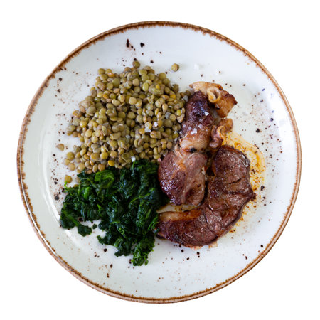 Nice dish of beef roast served with lentils and spinach on sideの写真素材