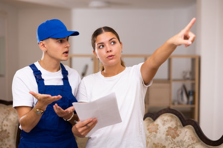 Builder attentively listens to the wishes of housewifeの写真素材