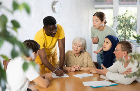 African american man conducting informal meeting with colleaguesの写真素材