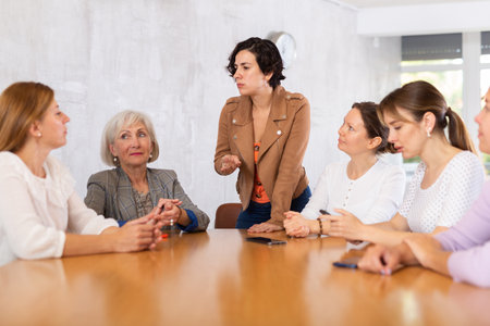 Women have discussion sitting at table in officeの写真素材