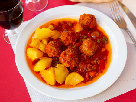 Spanish meatballs Albondigas in tomato sauce with potatoの写真素材