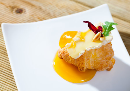 Camembert on croissant with honeyの写真素材