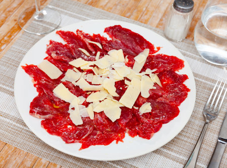 Sliced carpaccio. Raw beef meat on plateの写真素材