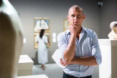 Man standing in museum hallの写真素材