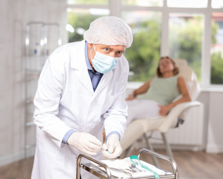 Senior male nurse makes preparations before blood drawing for analysis. Laboratory, emergency medicineの写真素材
