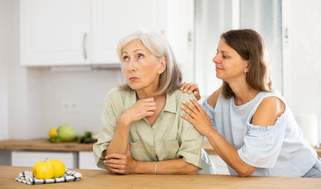 Woman encouraging her upset senior motherの写真素材