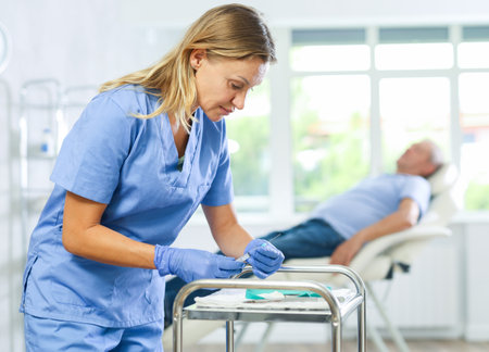 Female nurse conducts, makes necessary preparations before taking blood for analysisの写真素材