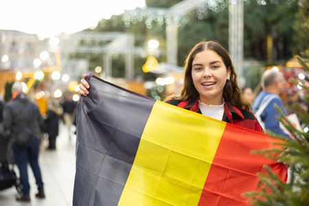 Womav waving of the Belgian flag at New Year street fairの写真素材