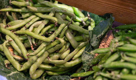 Bunch of green peas lies in vegetable shop