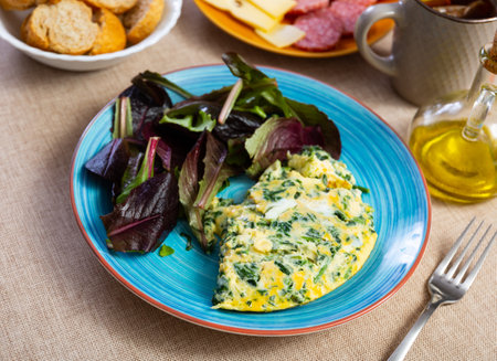 Omelette with spinach served on platterの写真素材