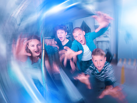 Friendly family has fun in the quest room, stylized as a laboratoryの写真素材