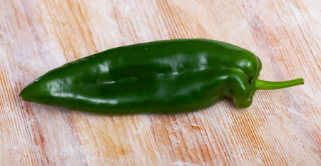 Green pepper on wooden tableの写真素材