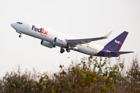 Cargo aircraft of FedEx Express ascending to sky from Barcelona
