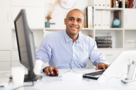 Successful businessman working with papers and laptop