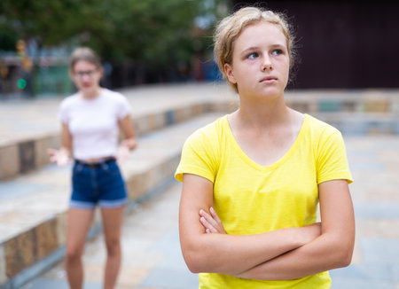 Youth girls quarreling between each other outdoorsの写真素材