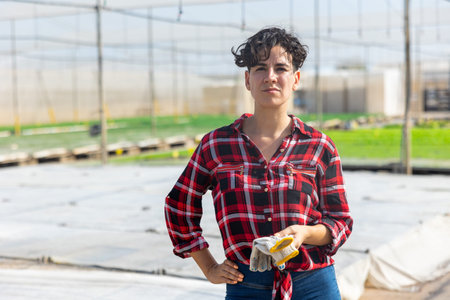 Portrait of woman gardener in hothouseの写真素材