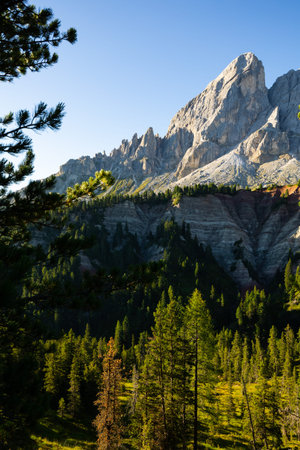 Mountain peak of Mont-de-Fornel, Dolomites stands majestically between sky and hilly valley