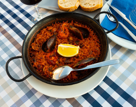 Popular dish of Spanish cuisine is paella with seafoodの写真素材