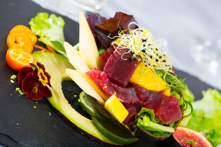 Image of delicious salad of raw tuna, mango, avocado and herbsの写真素材