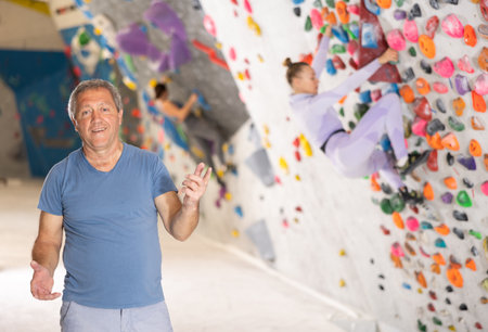 Adult man posing on climbing wallの写真素材